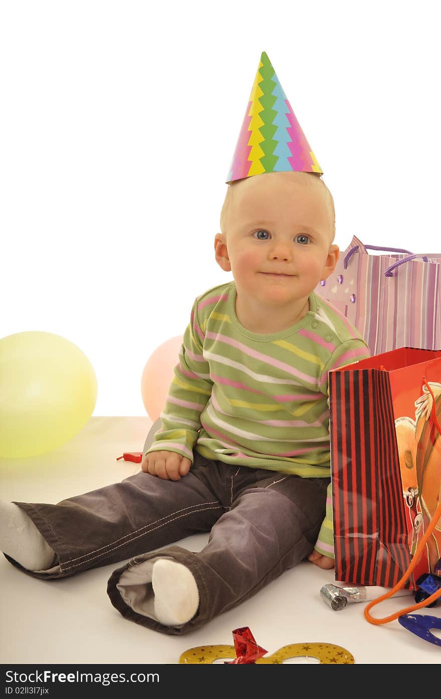 Little baby is sitting on the flor during birthday party. Little baby is sitting on the flor during birthday party