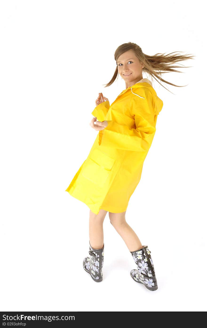 Happy and beautiful woman in yellow raincoat on rainy day