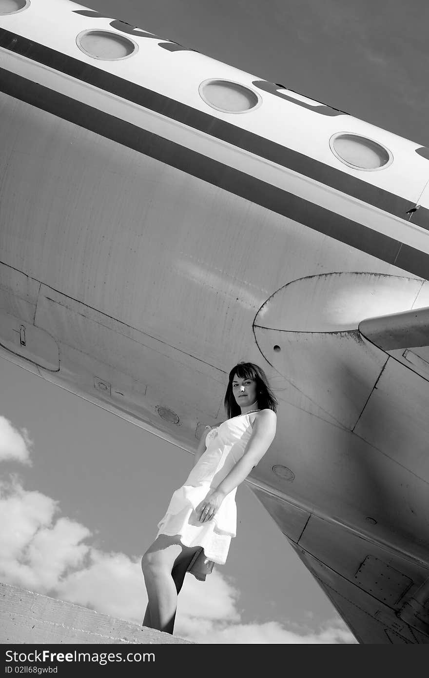 Girl posing with an airplane behind. Girl posing with an airplane behind