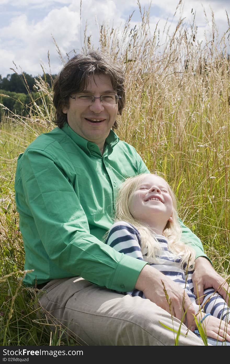 Father with daughter on meadow