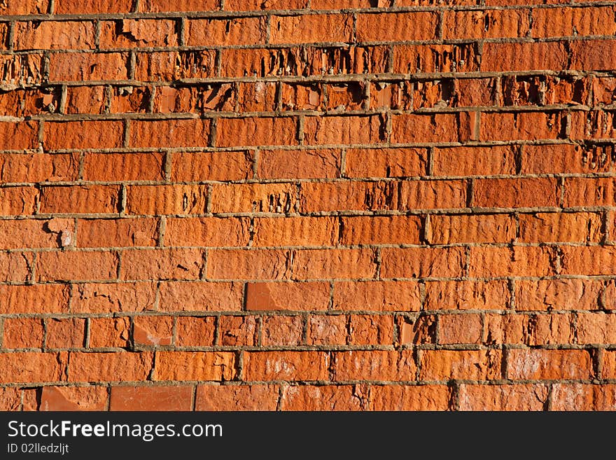 Destructive wall of red brick building