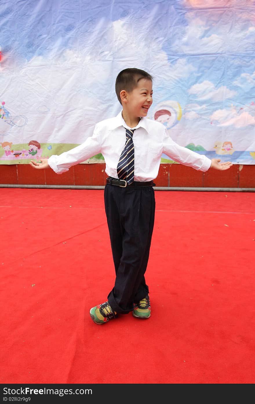 A student is performing on the stage on Children's Day in a primary school. A student is performing on the stage on Children's Day in a primary school.