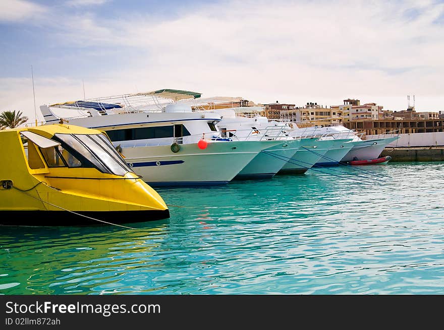 Expensive yachts in the turquoise harbor. Expensive yachts in the turquoise harbor.