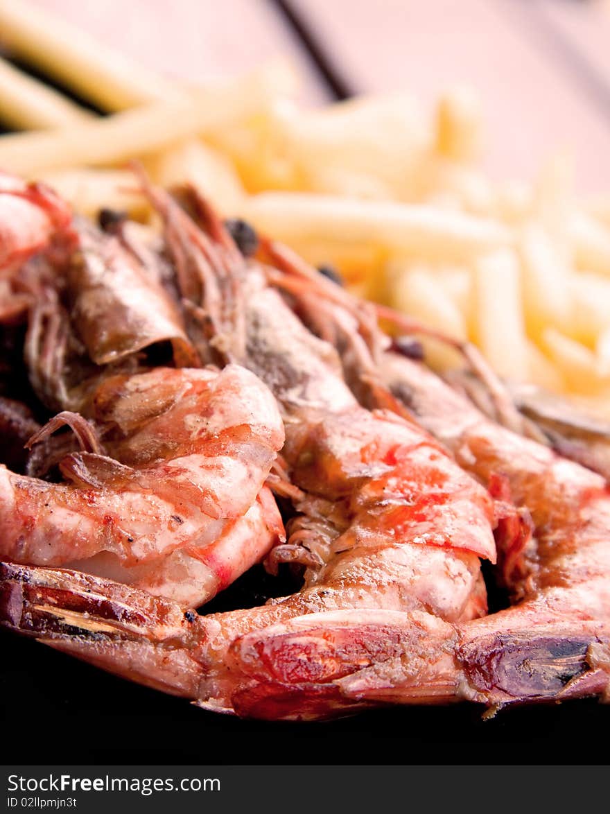 Prepared fried prawns and french fries. Prepared fried prawns and french fries