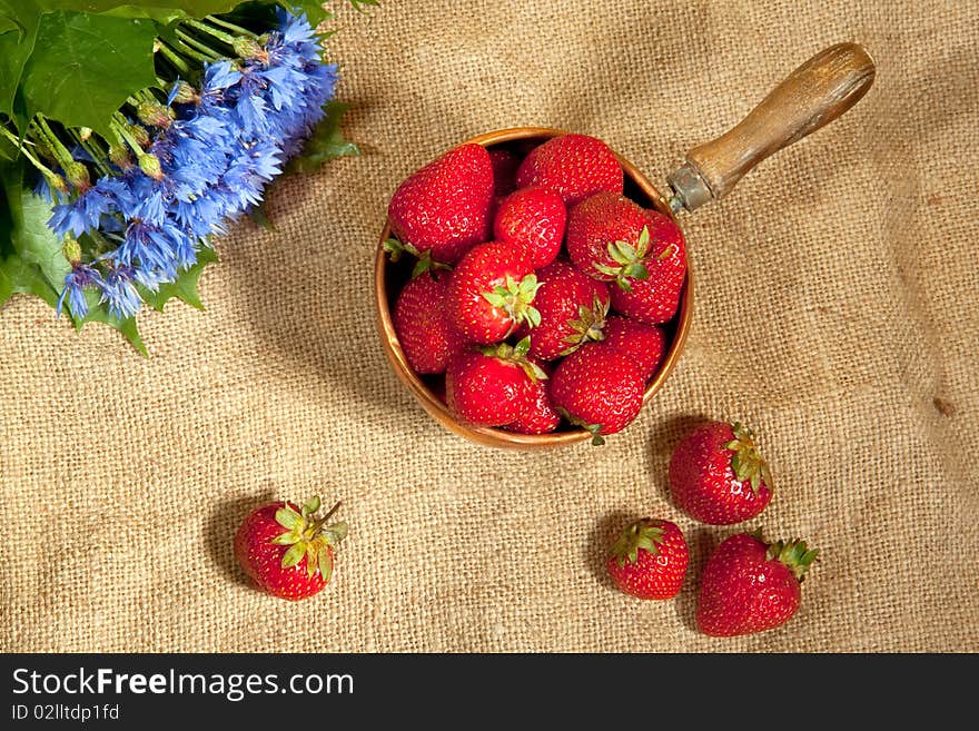 Fresh strawberry with bouquet of cornflower. Fresh strawberry with bouquet of cornflower