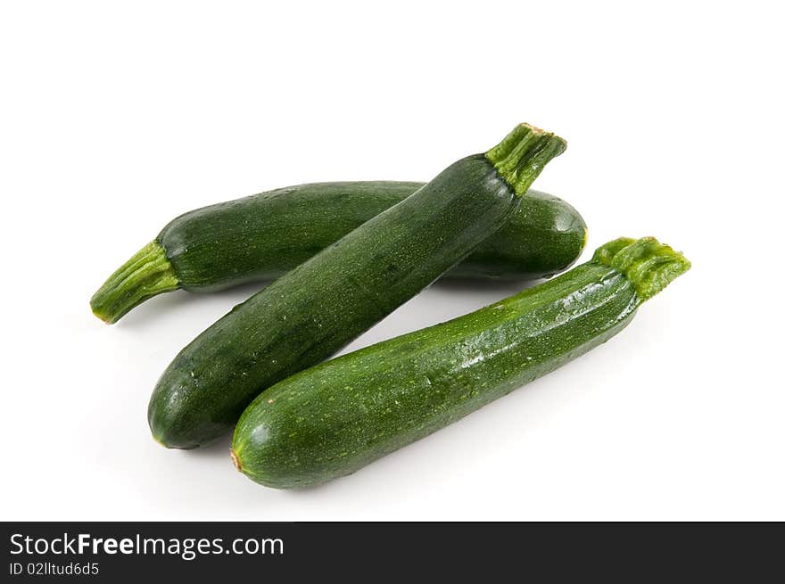 Three zucchini isolated on white background