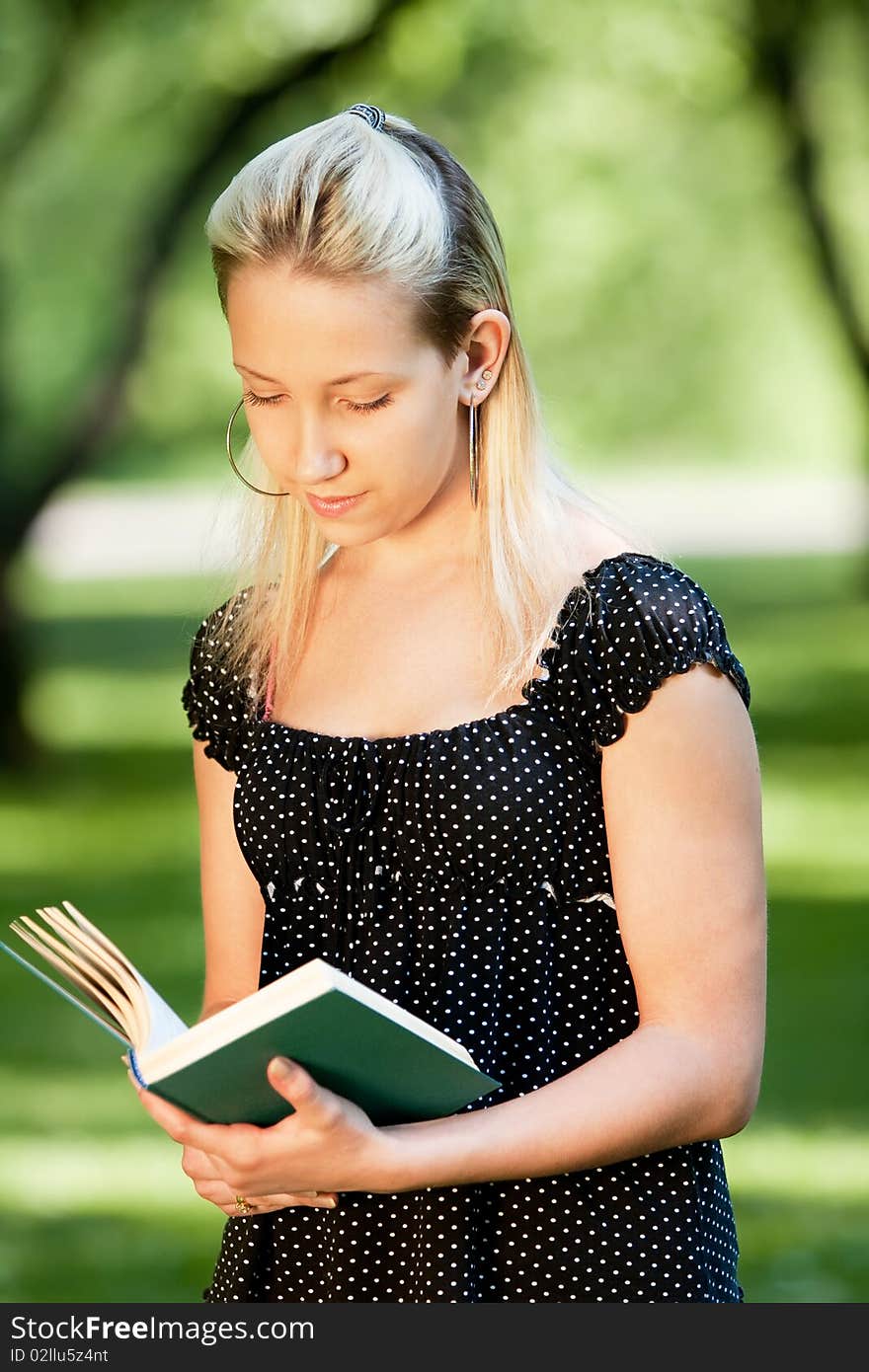 Girl with book in park