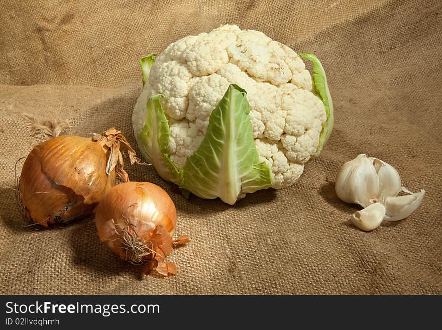 Still-life with cauliflower cabbage, onion and garlic