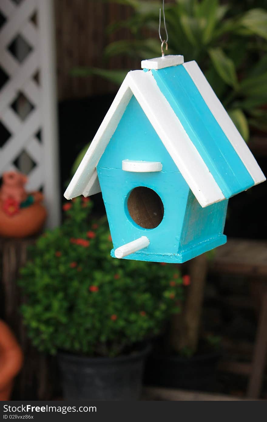 Blue bird house on blur background