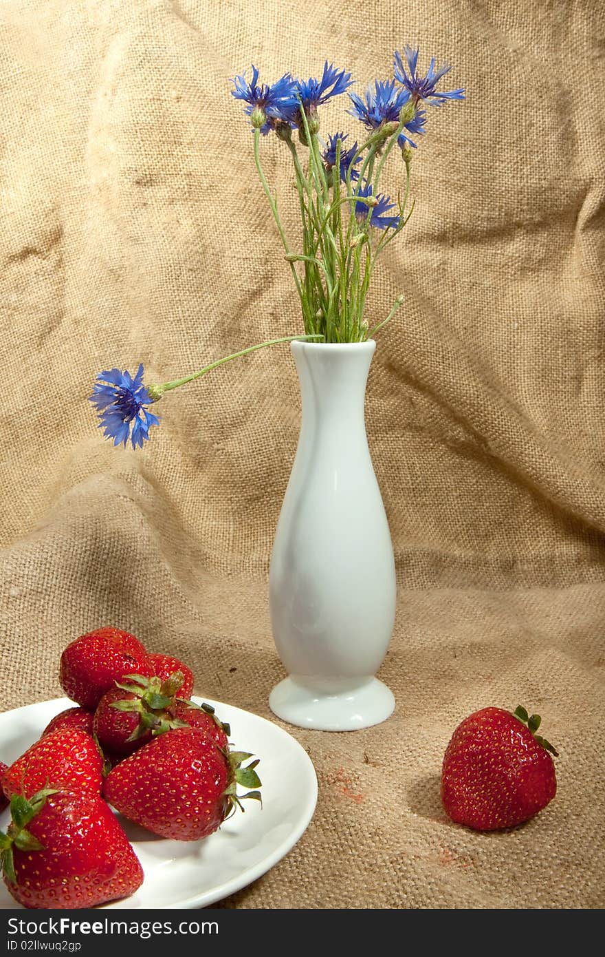 Fresh strawberry and vase with flowers. Fresh strawberry and vase with flowers