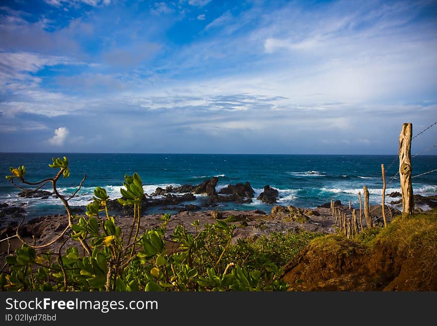 A rocky seashore with an old fence at famous Hookipa, Maui, Hawaii