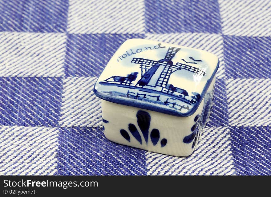 Ceramic pill box on a blue checkered kitchen towel