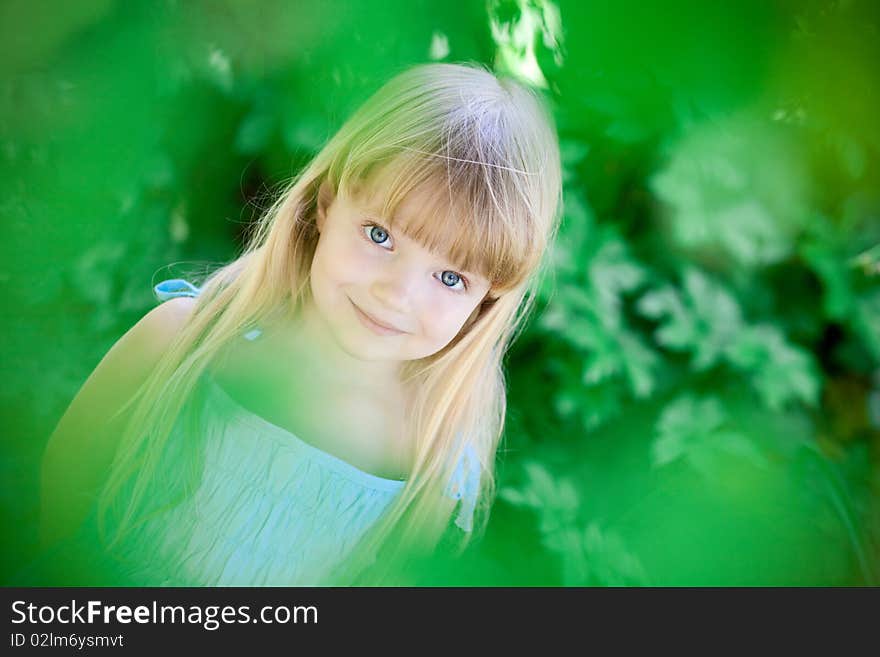 Little girl  under the trees