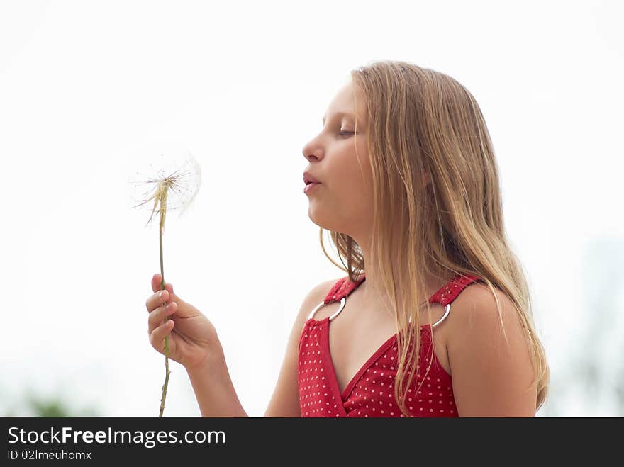 Girl with dandelion on a light background