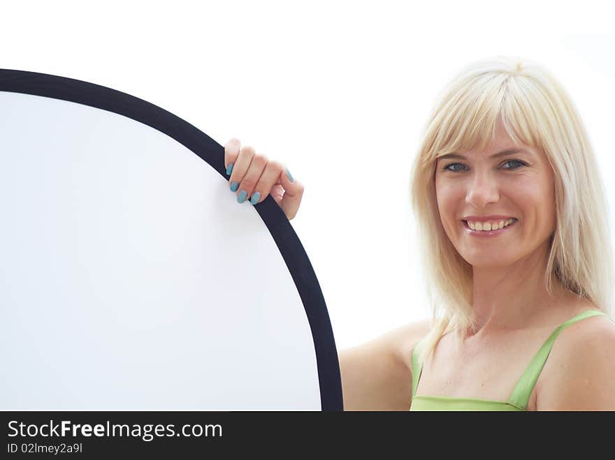 The woman hold in hands a photographic reflector