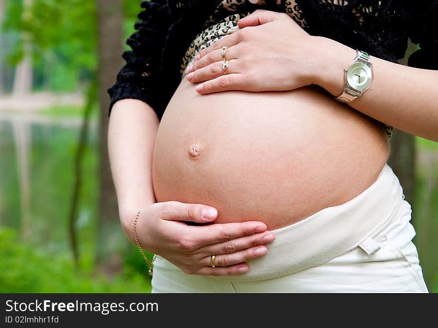 Pregnant woman in park. Outdoor shot. Pregnant woman in park. Outdoor shot