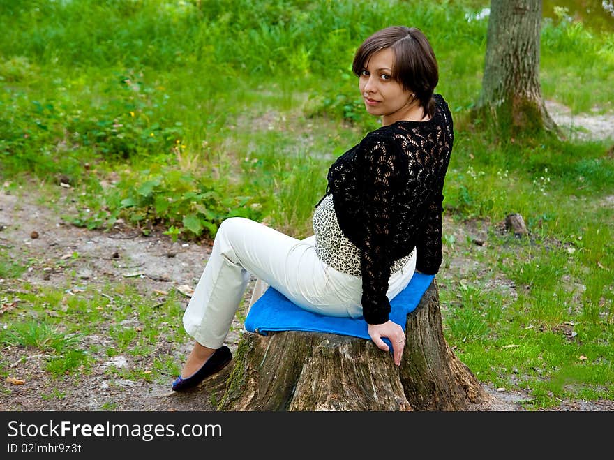 Beautiful pregnant girl in the park. Outdoor shot