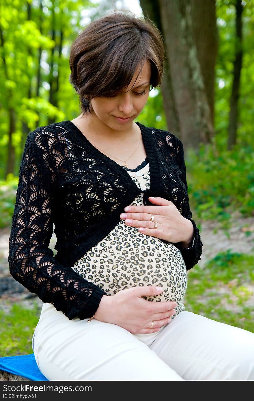 Pregnant woman in park. Outdoor shot. Pregnant woman in park. Outdoor shot