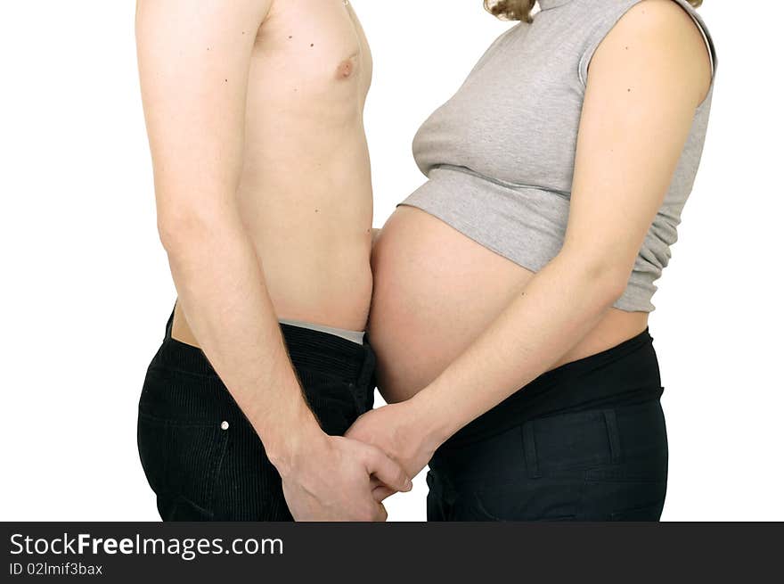 Happy couple expecting a baby are holding hands. Happy couple expecting a baby are holding hands