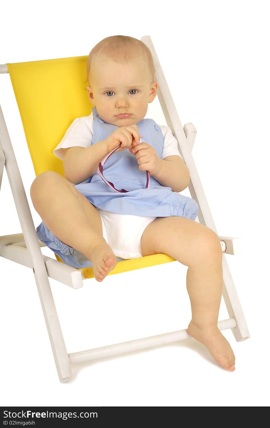 Baby with sunglasses sitting on yellow deckchair. Baby with sunglasses sitting on yellow deckchair