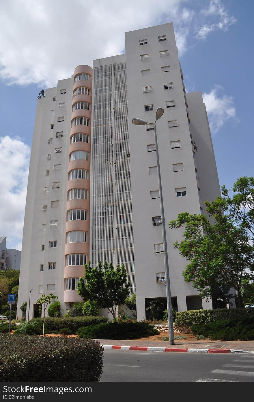 Front view urban apartment building with close balconies . Front view urban apartment building with close balconies .