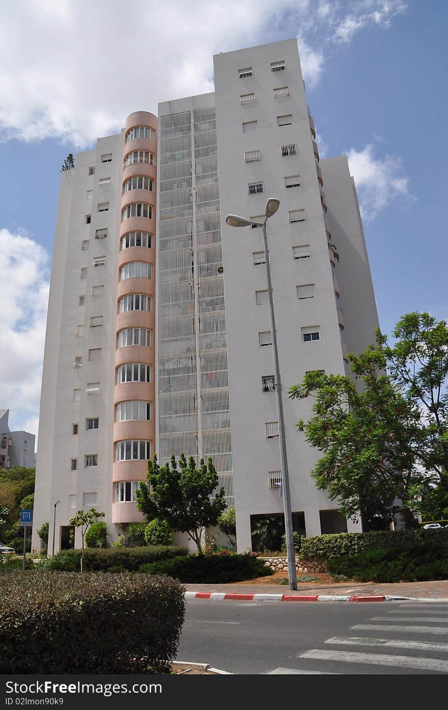 Front view urban apartment building with close balconies . Front view urban apartment building with close balconies .