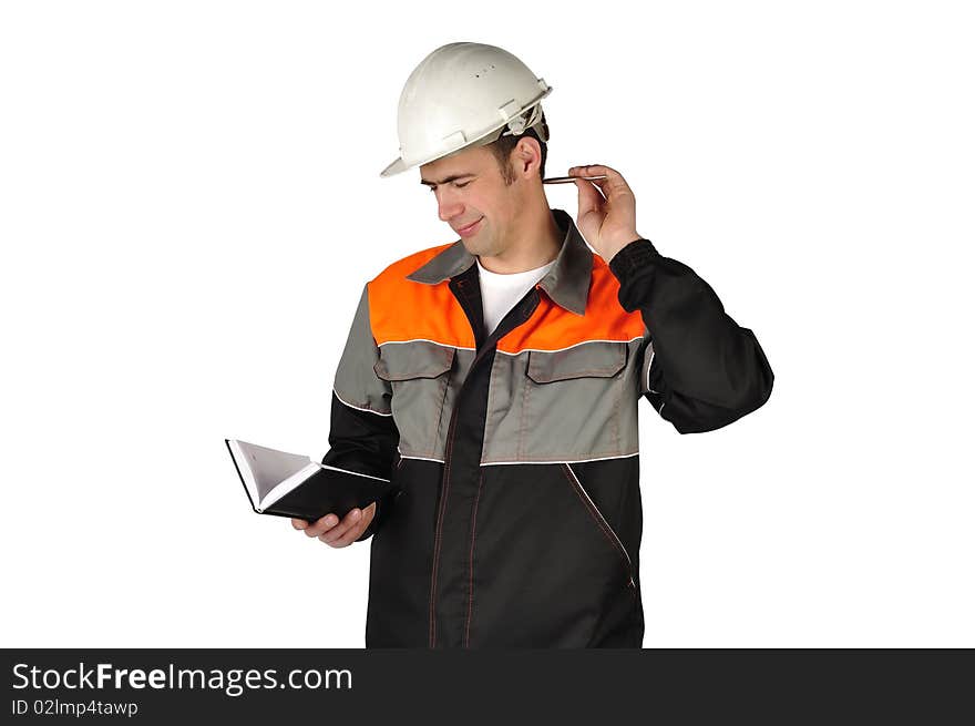 The chief engineer in a helmet writes in a notebook on a white background