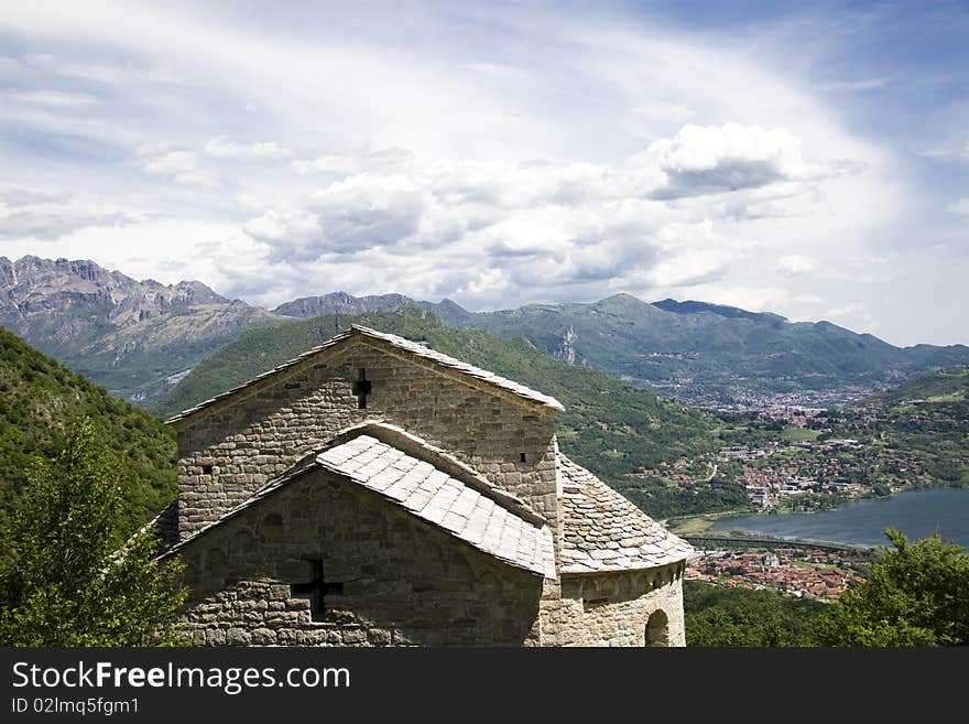 Old church with mountains in the background on a cloudy day. Old church with mountains in the background on a cloudy day