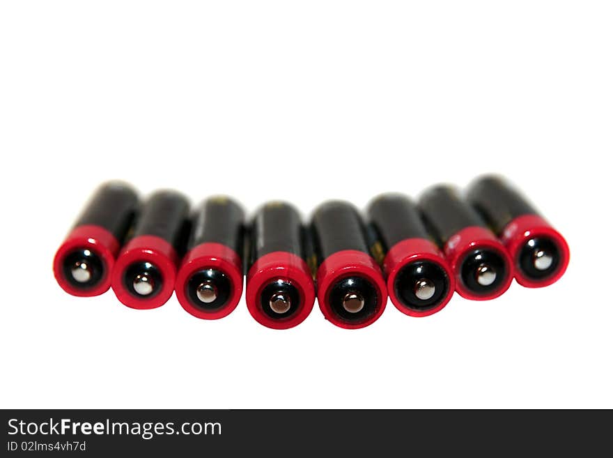 Batteries grouped together in a row against a white background. Batteries grouped together in a row against a white background