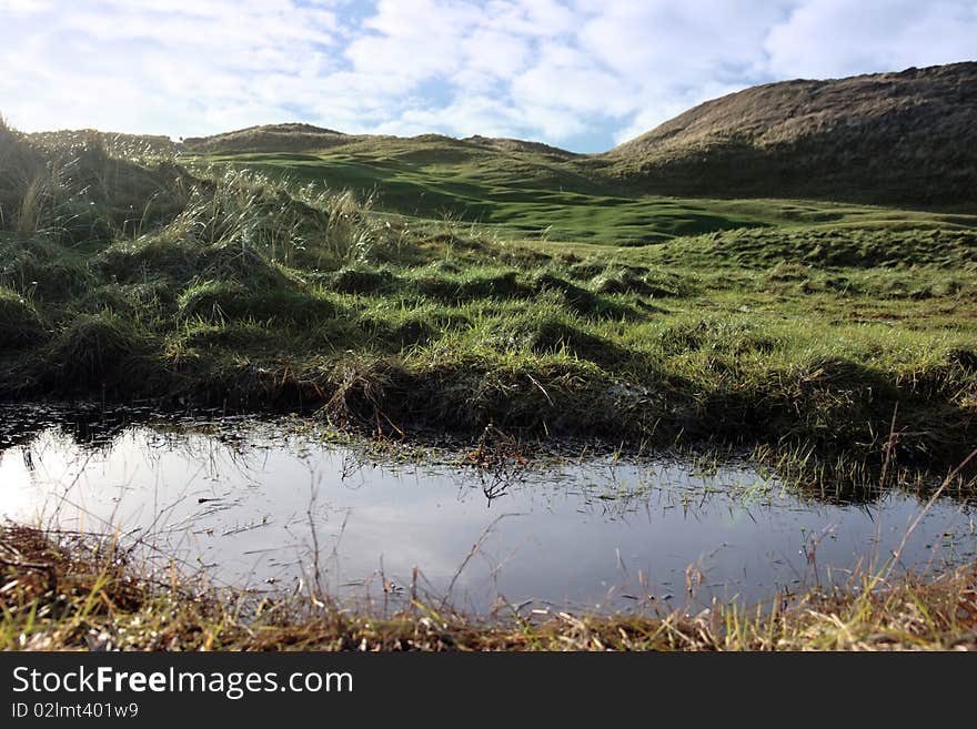 A water trap on a links golf course in ireland. A water trap on a links golf course in ireland