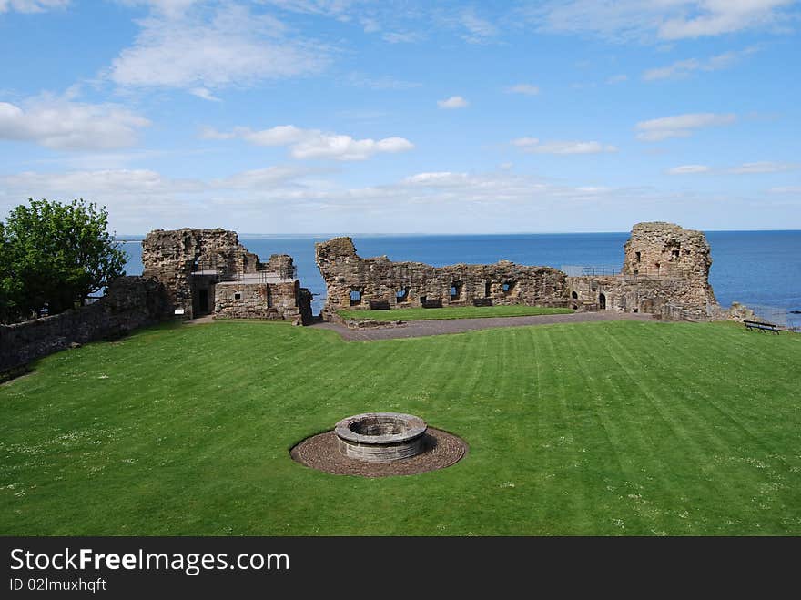 The ruined sea wall and the remains of a medieval castle at St. Andrews. The ruined sea wall and the remains of a medieval castle at St. Andrews