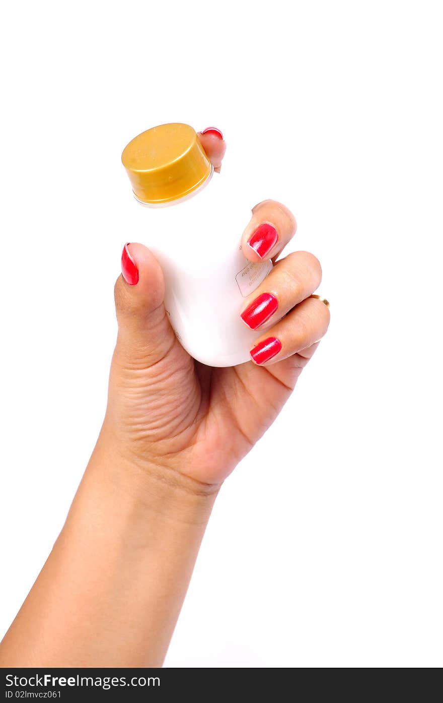 Female hand holding medicine bottle.