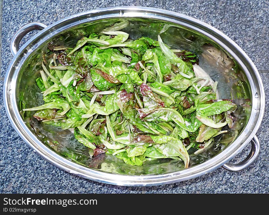 Lettuce salad with  dressing in a pot