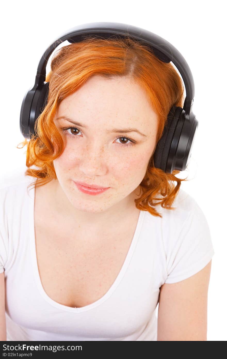 Redhead gilr with headphones isolated on white