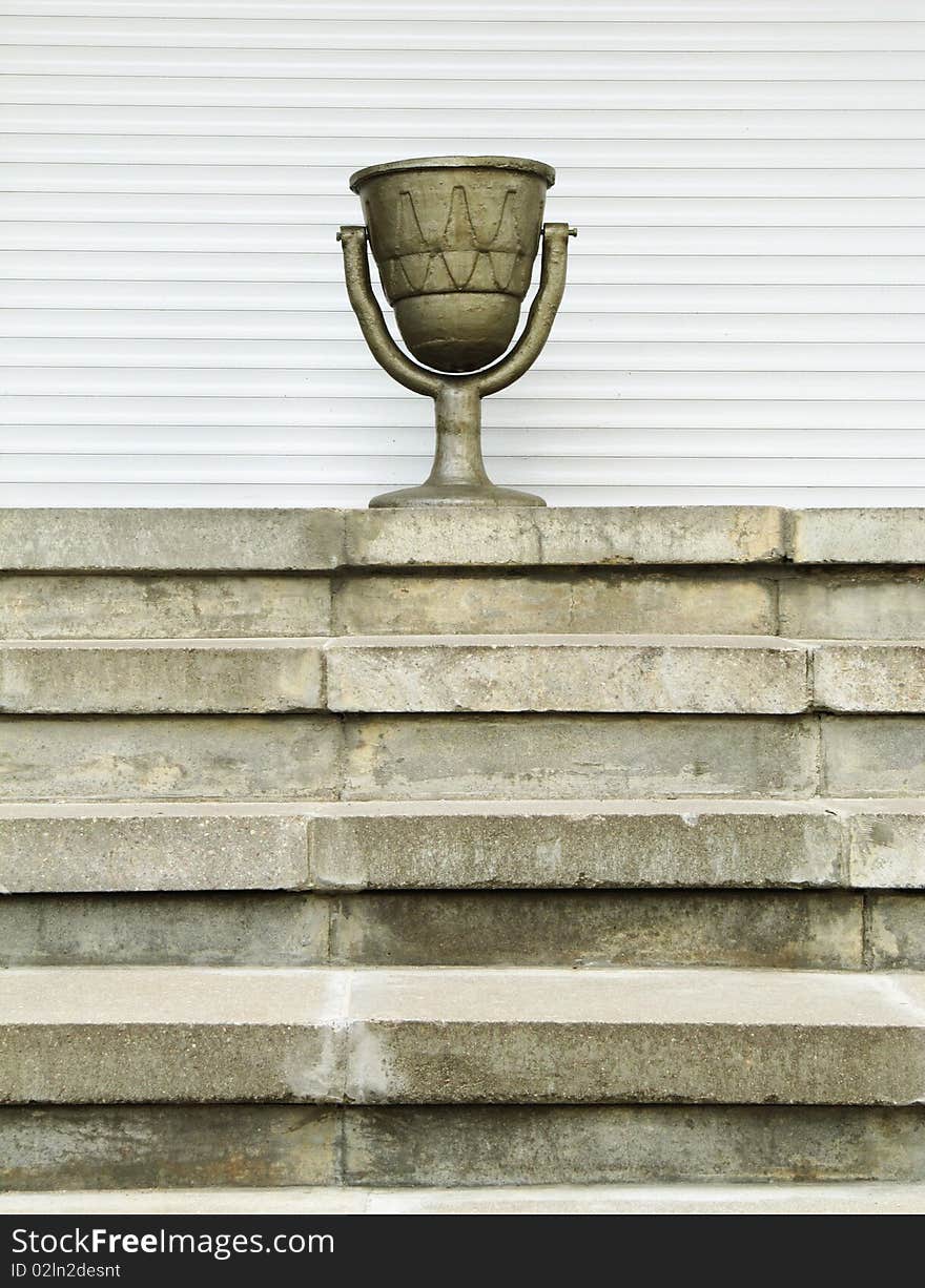 Old Urn  On A Ladder, On A White Background