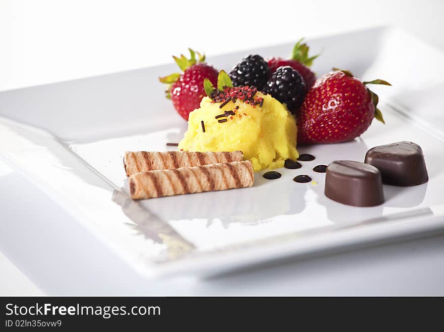 Elegant dessert plate with sorbet,fruit,cookies and chocolate. Elegant dessert plate with sorbet,fruit,cookies and chocolate