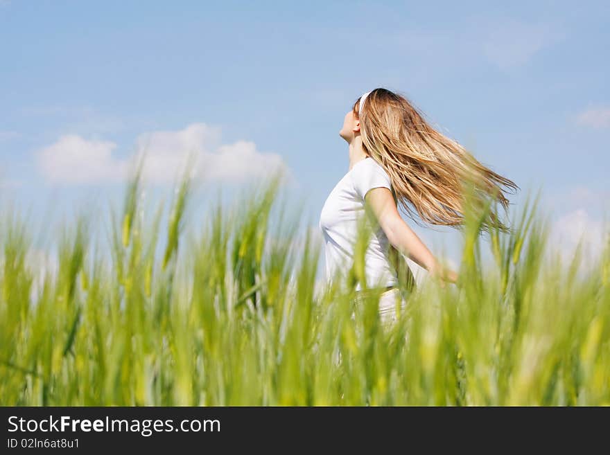 Young happy girl in green field. Young happy girl in green field