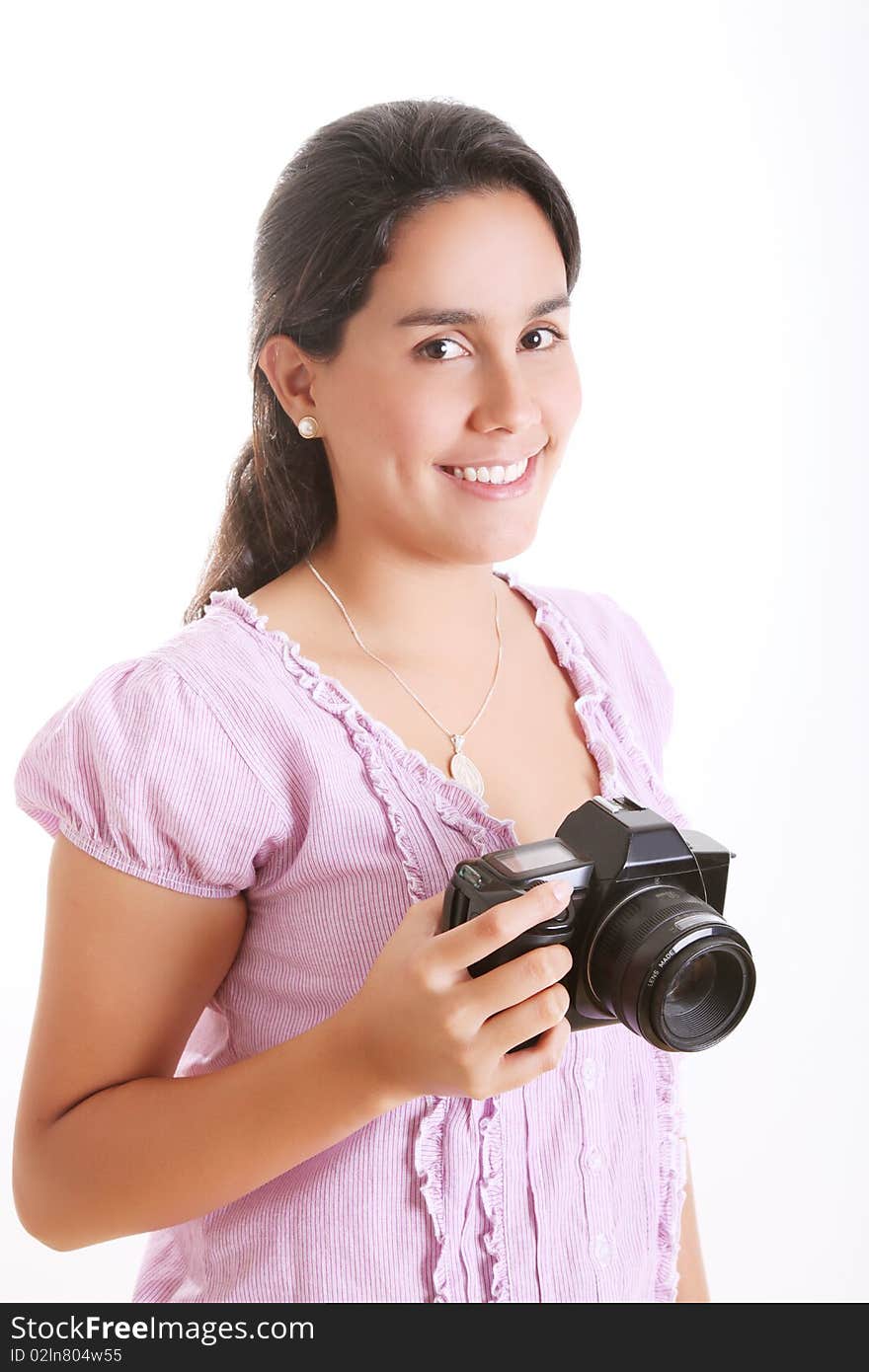 Young girl with a camera in his hands looking at the camera and smiling