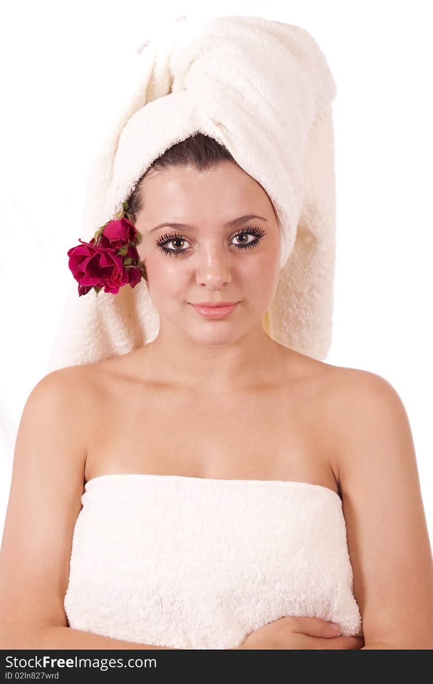 Beautiful spa woman with towel on head and roses