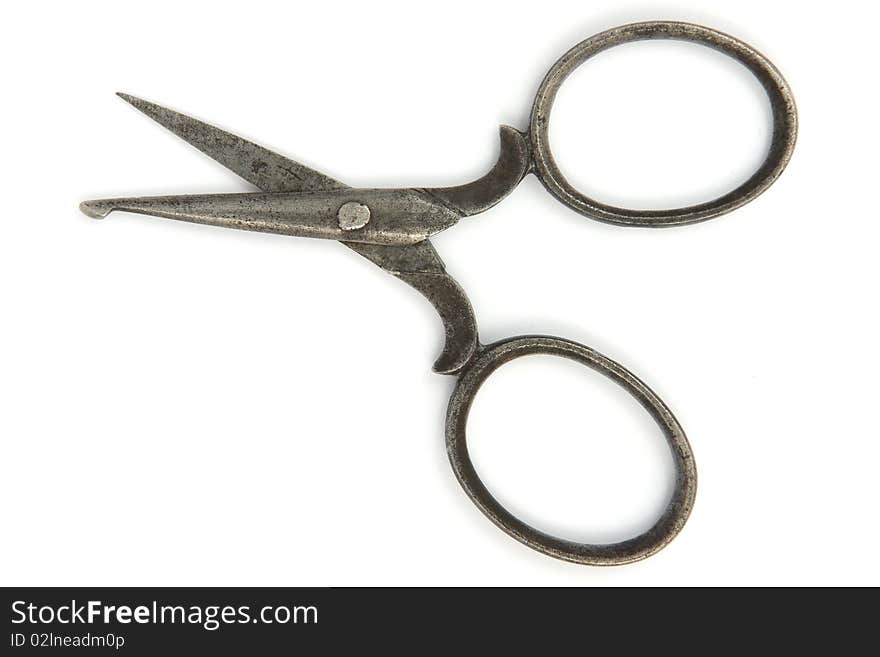 Ancient open scissors on white background