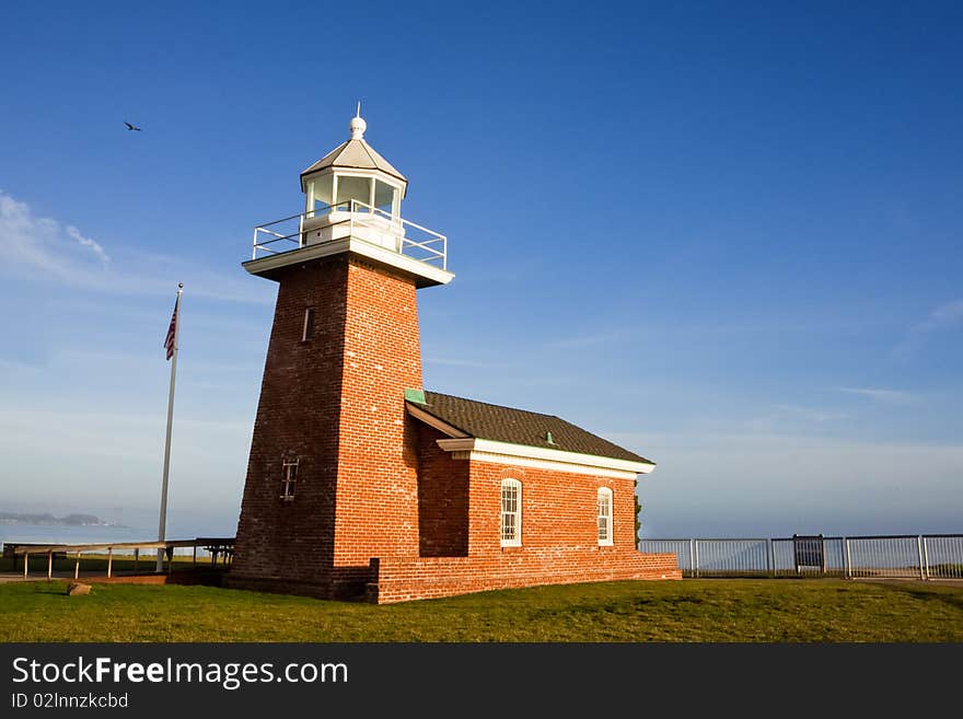 A light house with blue sky. It's located in Santa Cruz, California, United States. It's a landmark of Santa Cruz.