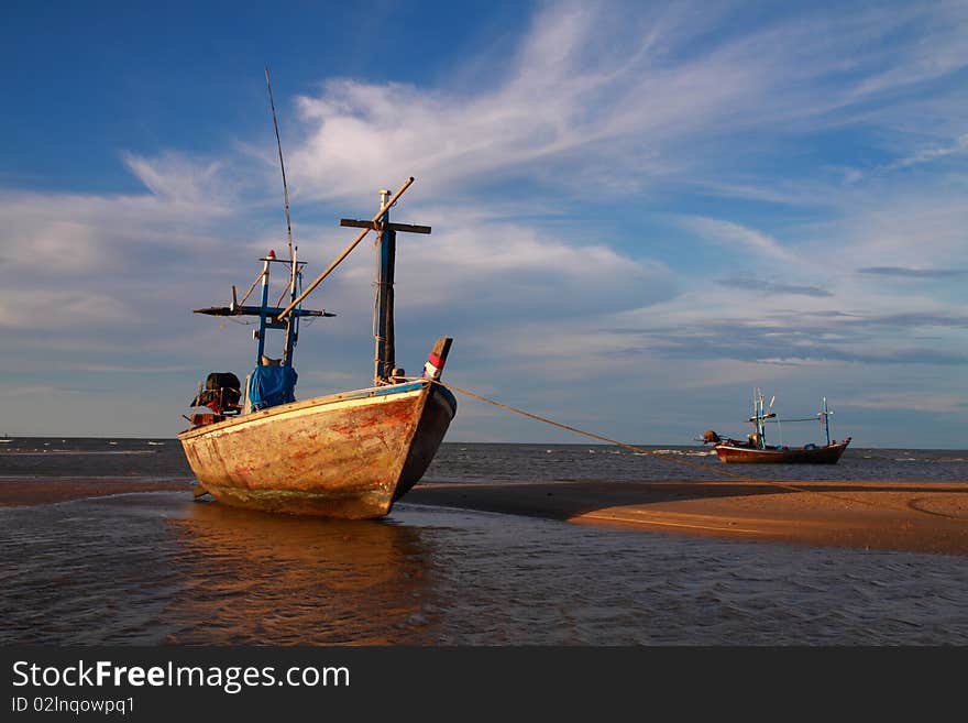 Fisherman boat lying on the tropical beach