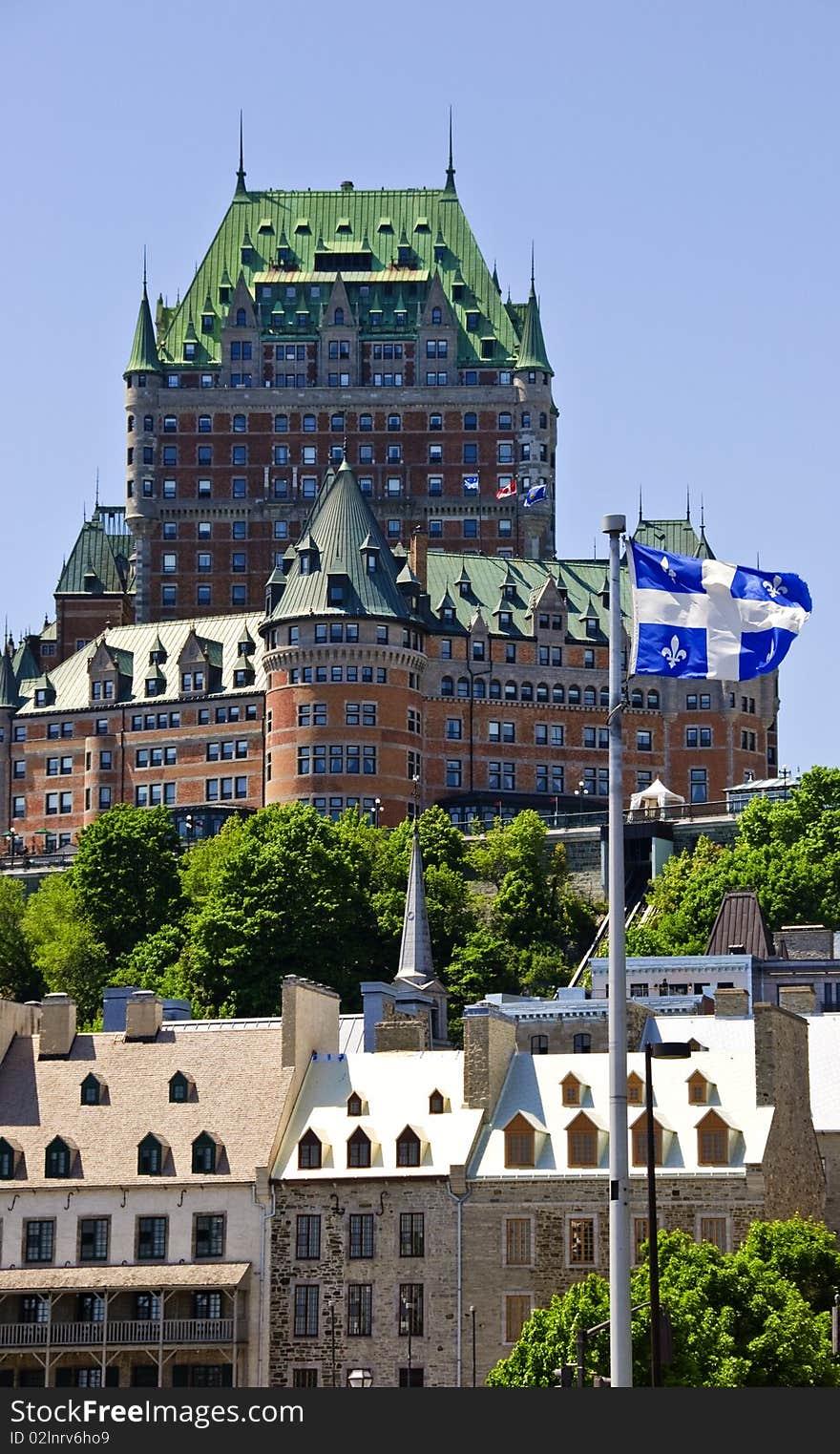 Flag of quebec blowing in front of historic castle on hill. Flag of quebec blowing in front of historic castle on hill