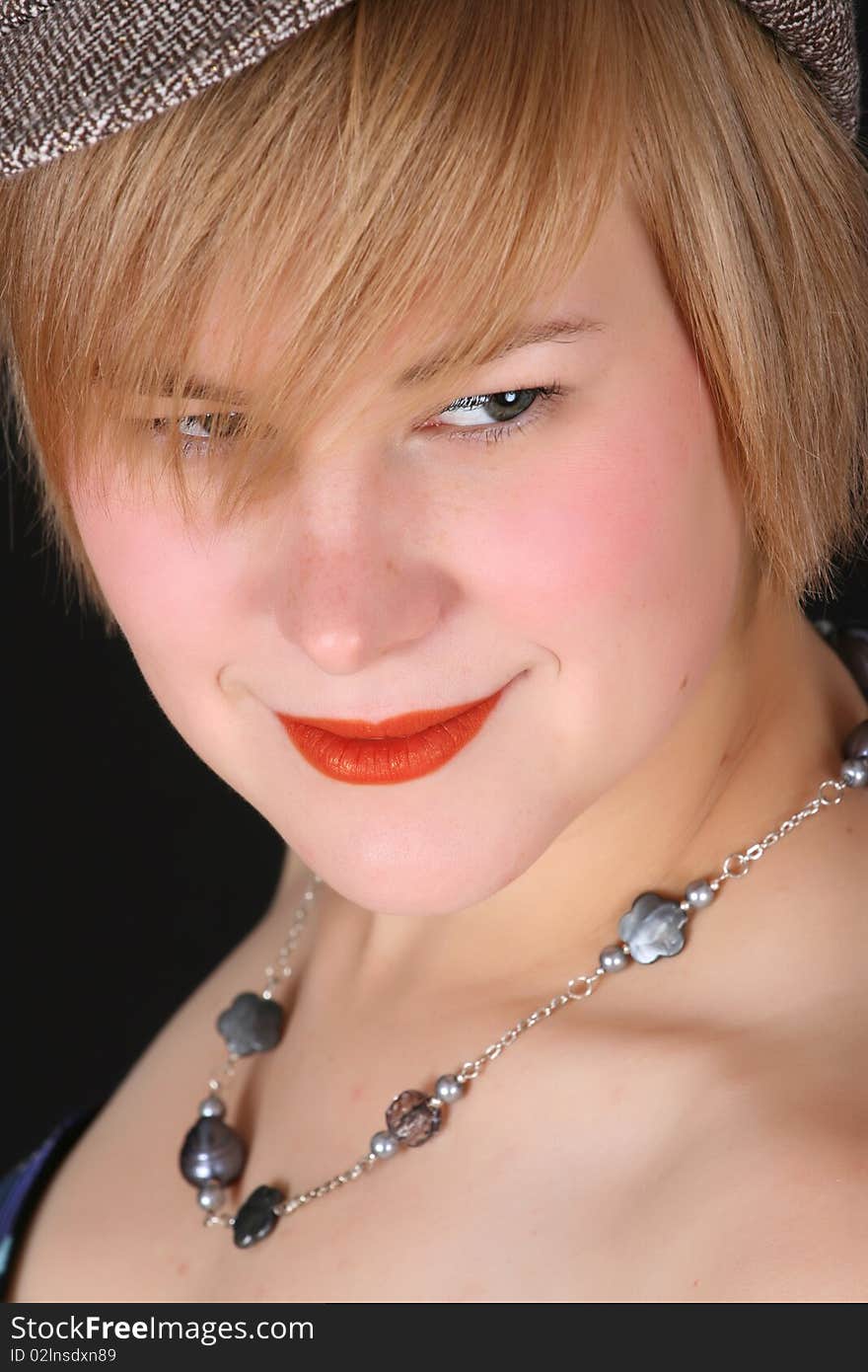 Beautiful young caucasian female wearing a hat and necklace. Beautiful young caucasian female wearing a hat and necklace