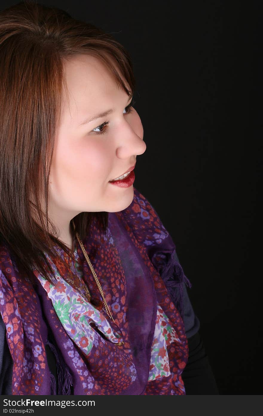 Headshot of beautiful brunette female on a black background