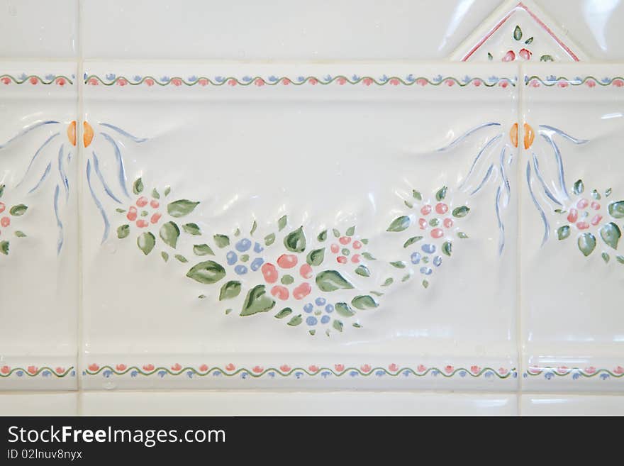 White Bathroom tiles with a floral pattern; in horizontal orientation