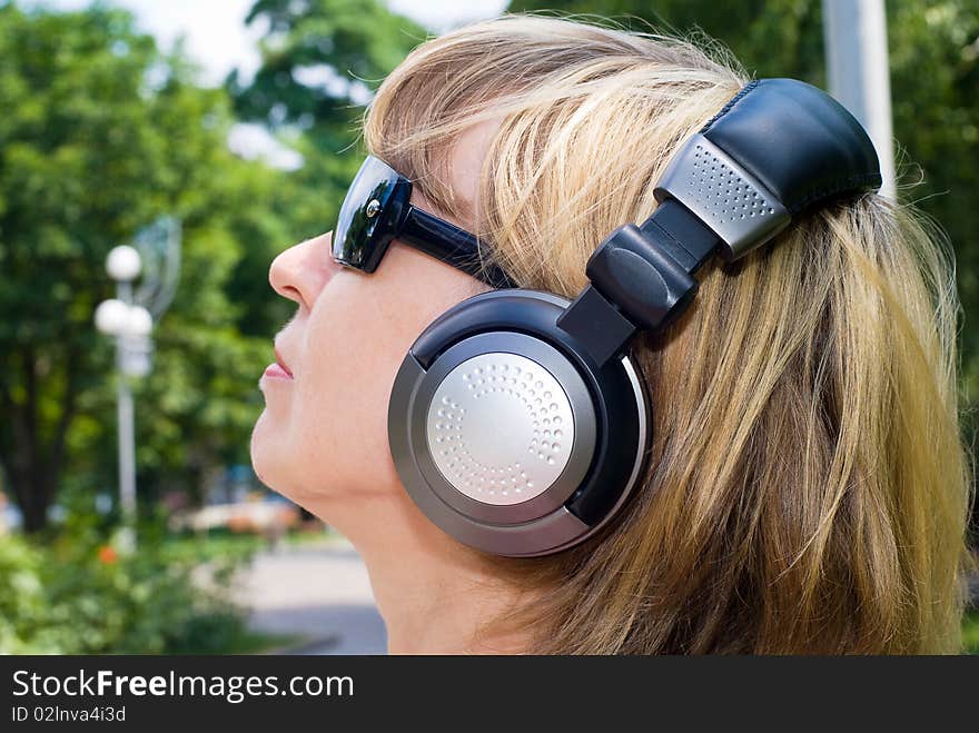 Young woman listening music in park