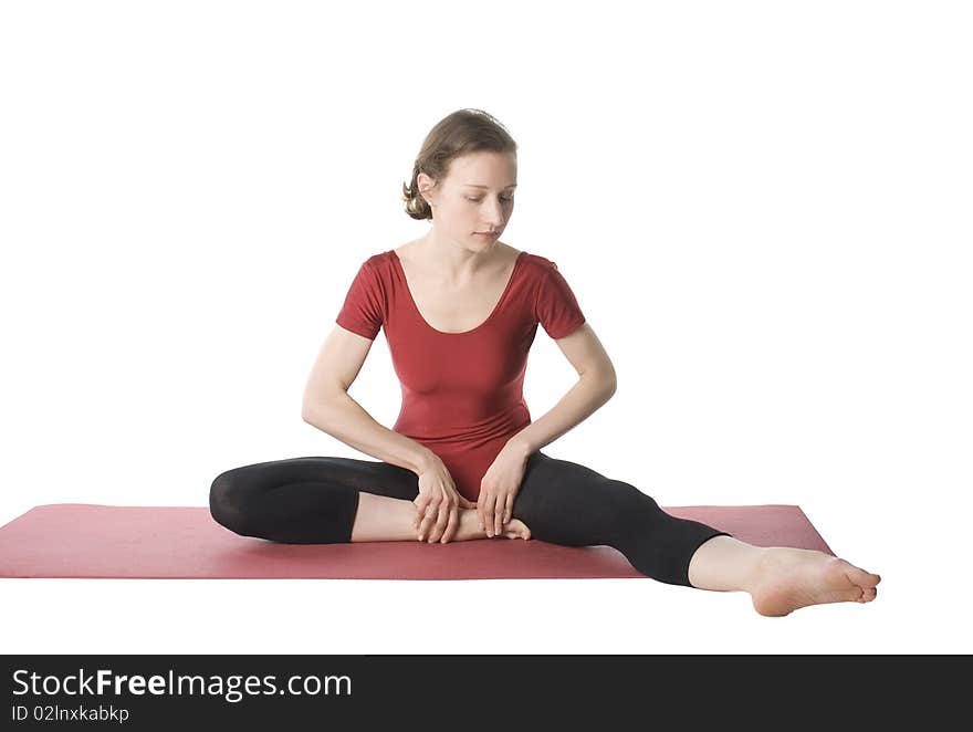 Woman exercising on a mat over white background. Woman exercising on a mat over white background