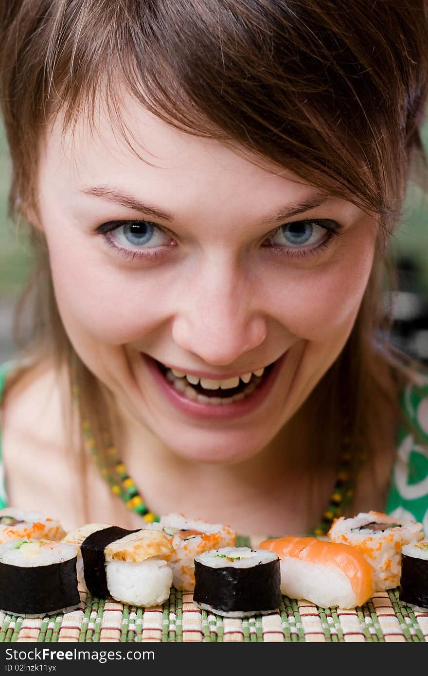 An image of a young woman eating sushi