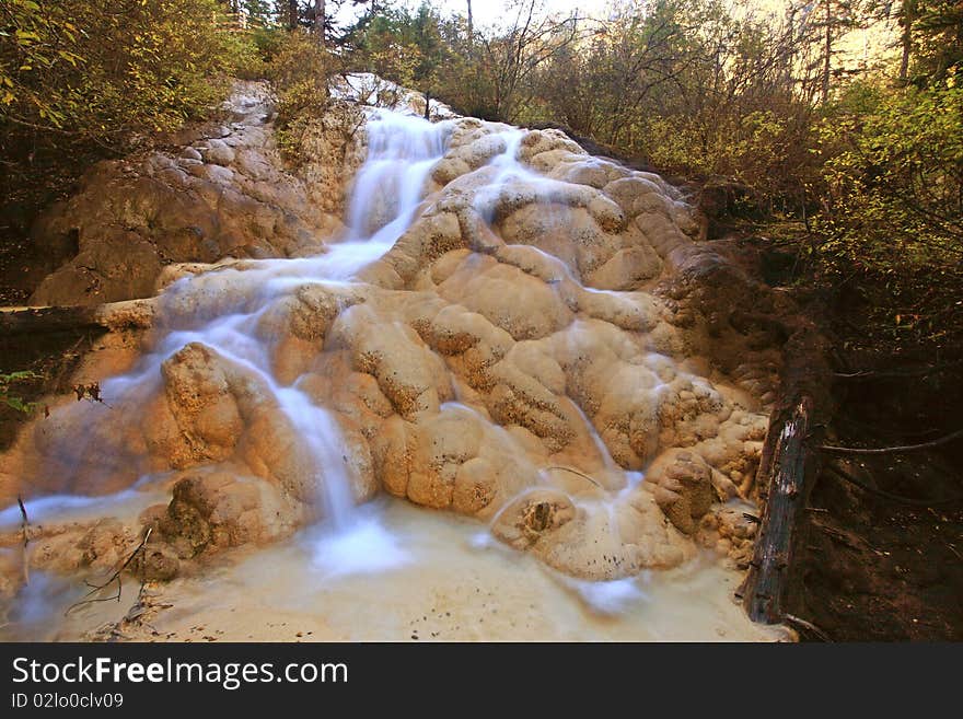 Misty stream running over yellow rocks .Sichuang.China. Misty stream running over yellow rocks .Sichuang.China